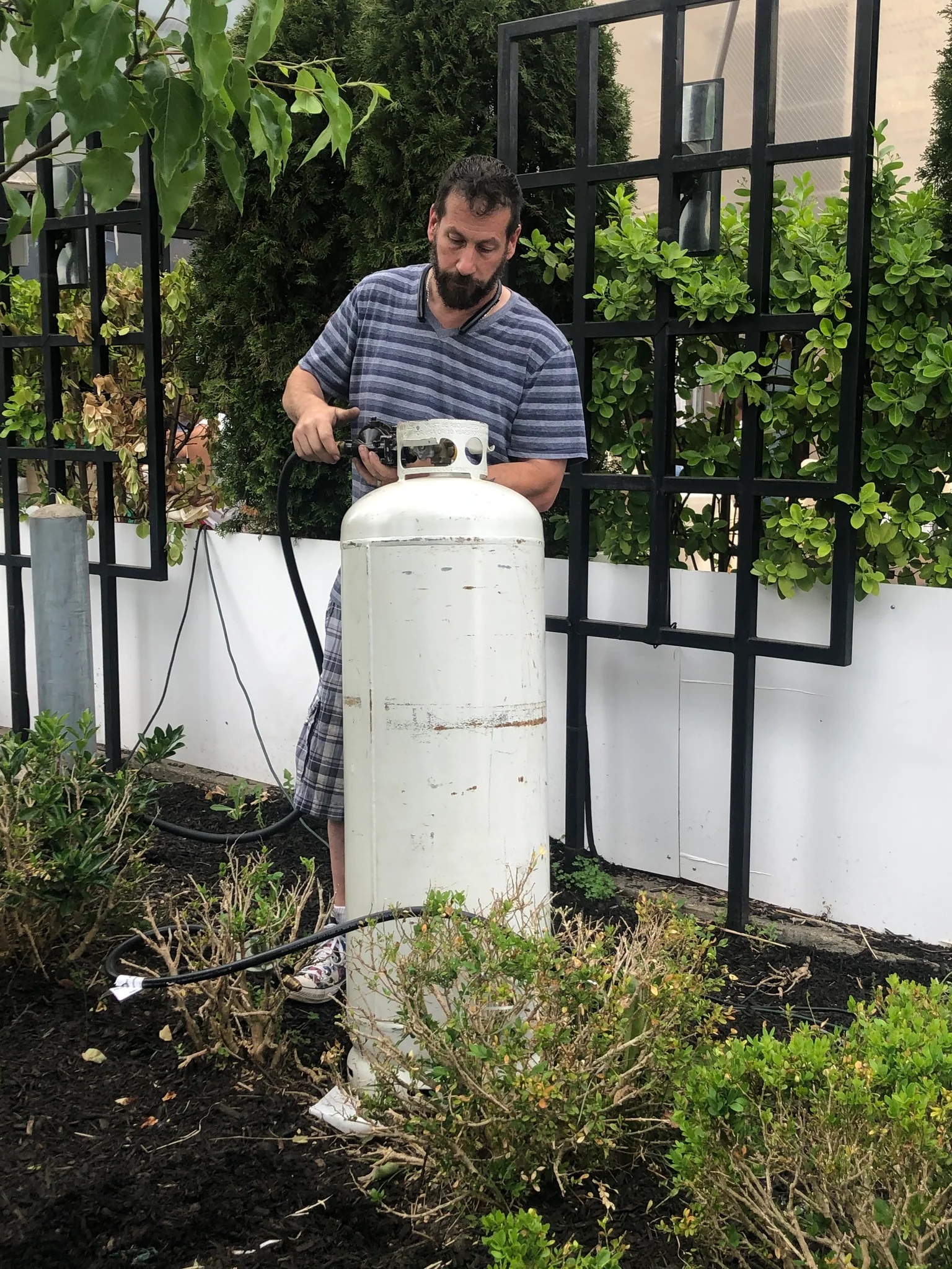 a man connects a propane tank